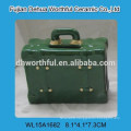 Colorful ceramic piggy bank in suitcase shape